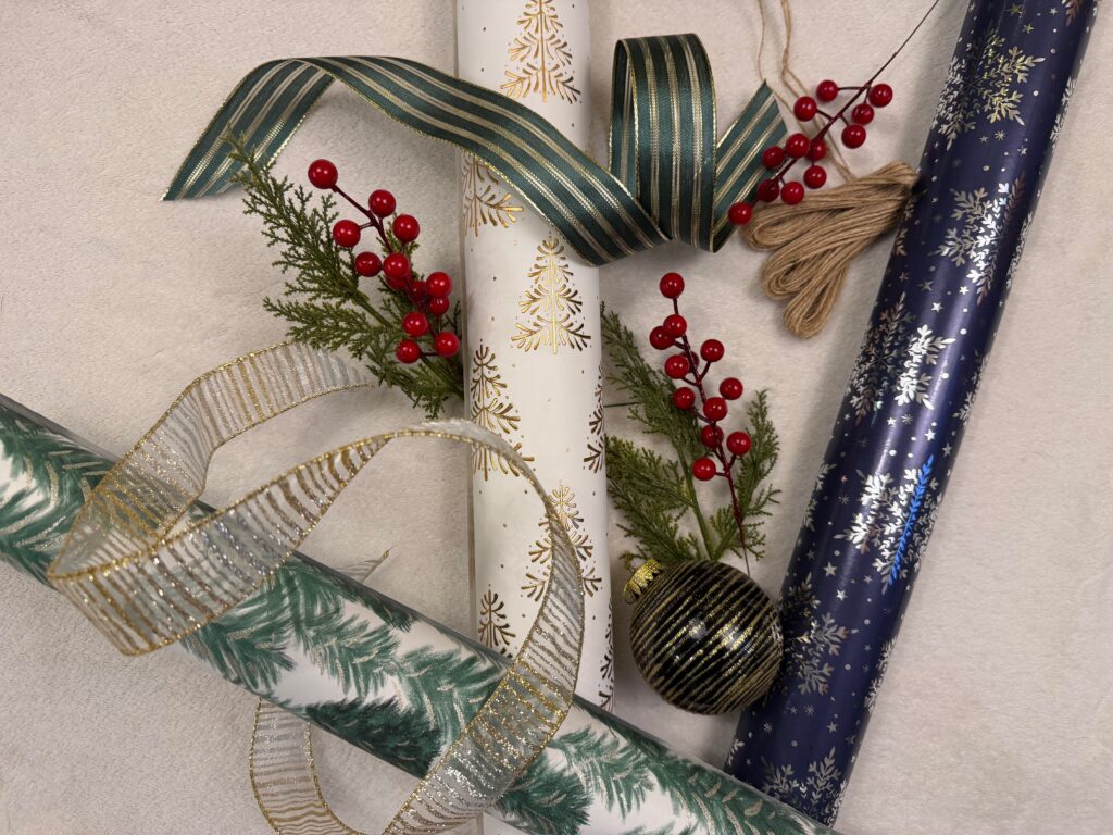 Holiday printed gift wrap with textured ribbons and botanical embellishments