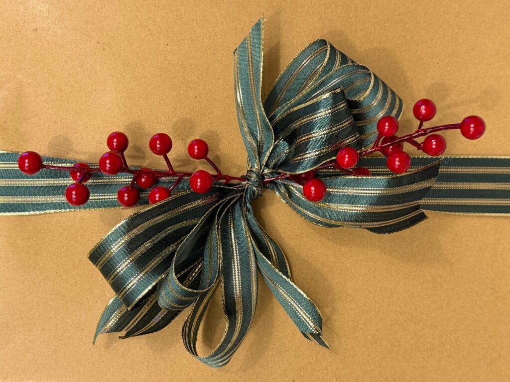 Handcrafted wired ribbon bow with sprigs of holiday berries
