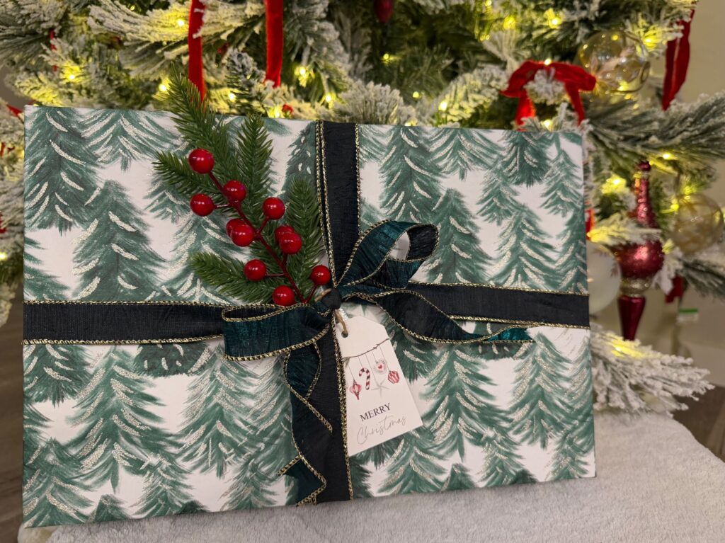 Winter themed holiday gift wrapping with dark ribbon and berry embellishments